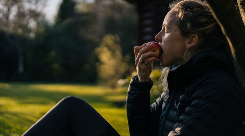 She leans against tree, deep in thought